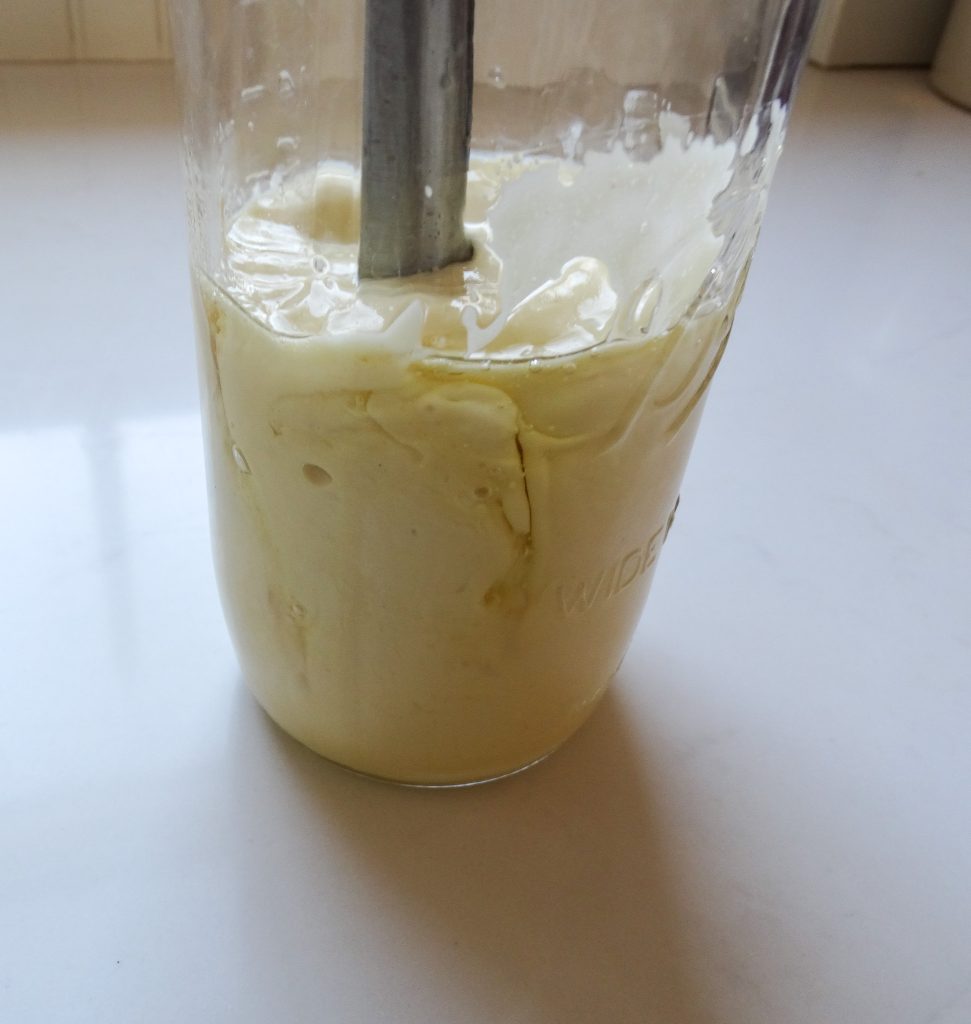 Homemade mayo in a jar sitting on a counter