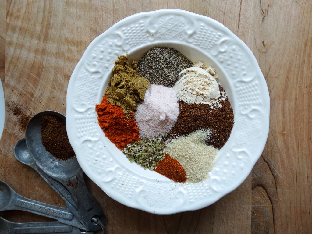 taco seasoning ingredients in a white bowl on a cutting board